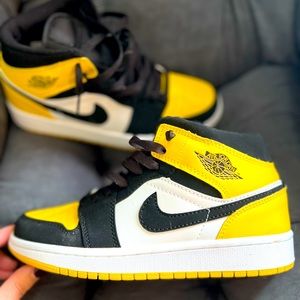 Black, gold, and white Nike Air Force